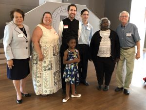 Pictured left to right Virginia Hardy, Laura Miller, Father David Schalk, Gino Dimattia, Liz Carle, Tom Murphy and holding the Crucifix Iyonna Godfrey